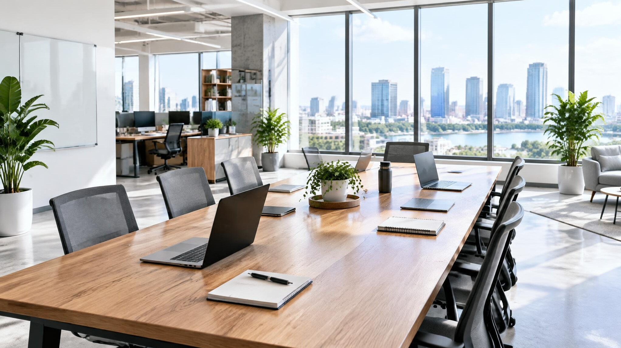 Bright modern open office with a long table and large windows