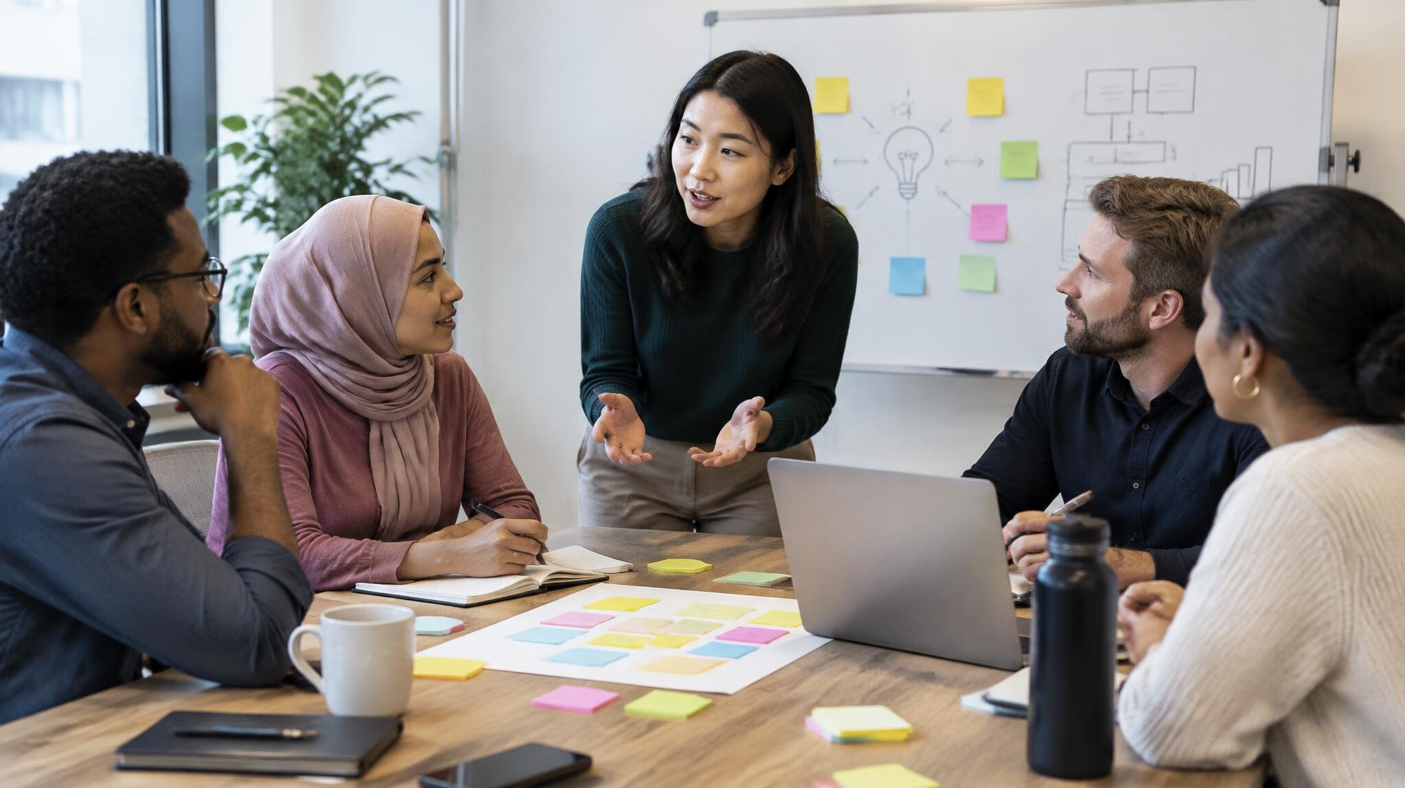 Group workshop around a table with sticky notes