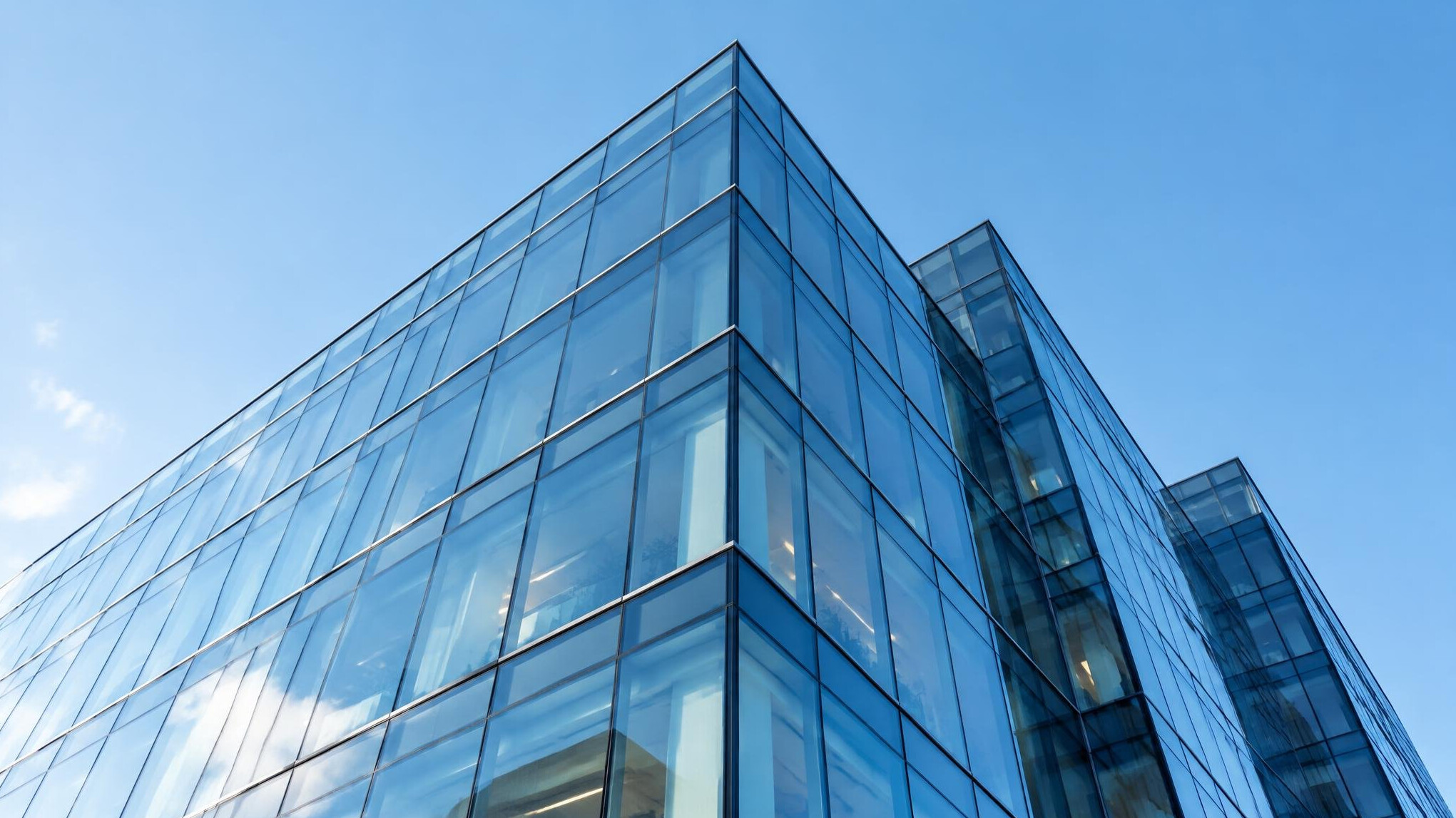 Glass office building facade seen from below
